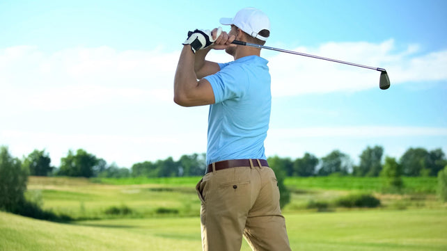 golf player hitting ball in draw position at course