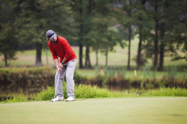 Golfers are putting golf in the course golf