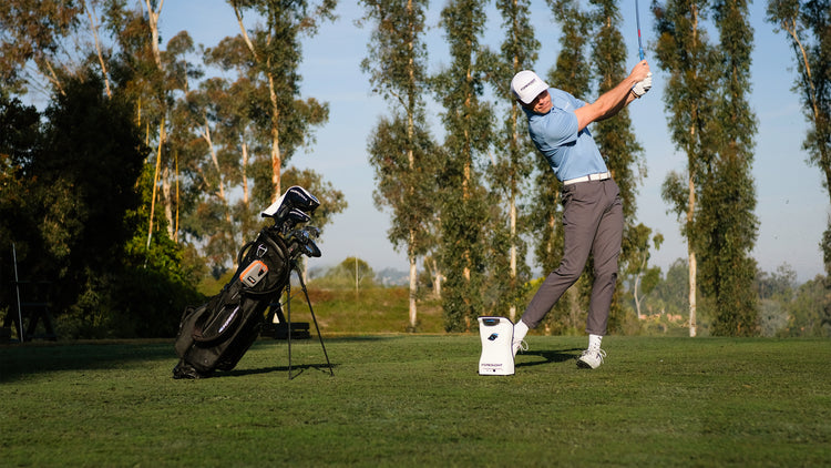 professional golfer using launch monitor on the greens professional golfer using launch monitor on the greens
