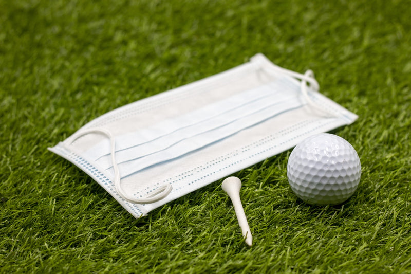 face mask for golfer on green grass