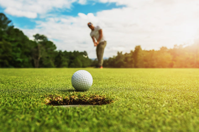 man putting a golf ball