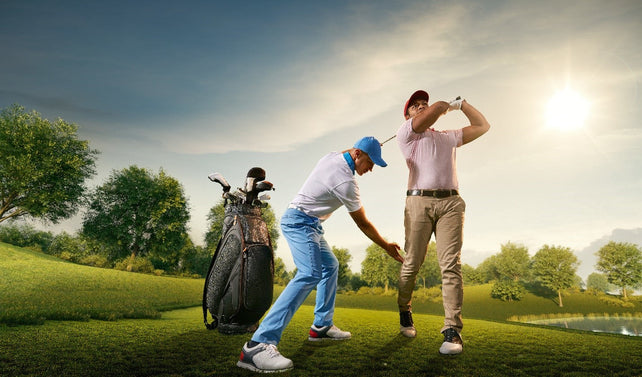 golf instructor adjusting mans golfing stance