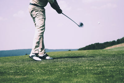 Golfers hitting the golf ball