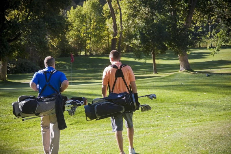 Golfers walking on fairway
