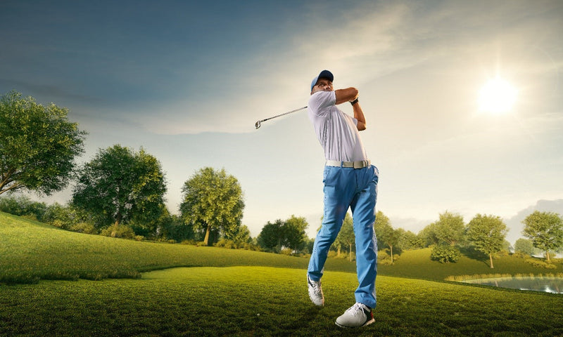 man swinging golf club behind him
