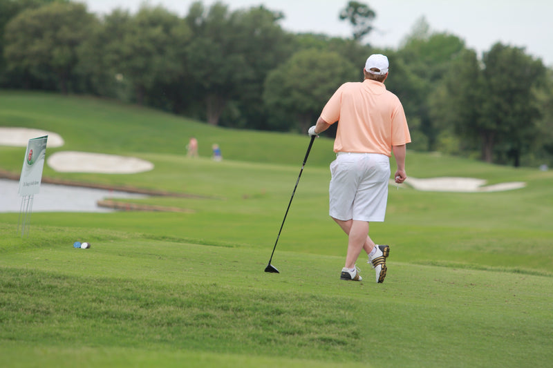 A golfer playing on a course.