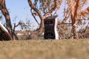 A man on the driving range using a GCQuad Launch Monitor