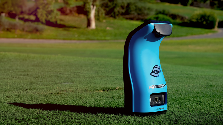 foresight sports gc3 golf launch monitor sitting on a lush green golf course