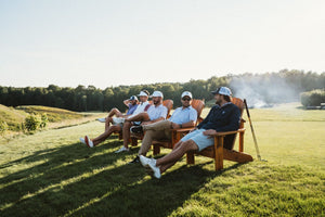 golfers lounging on the putting greens