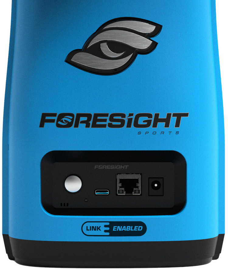 Wiew of the back of a launch monitor, focused on the logo and ports