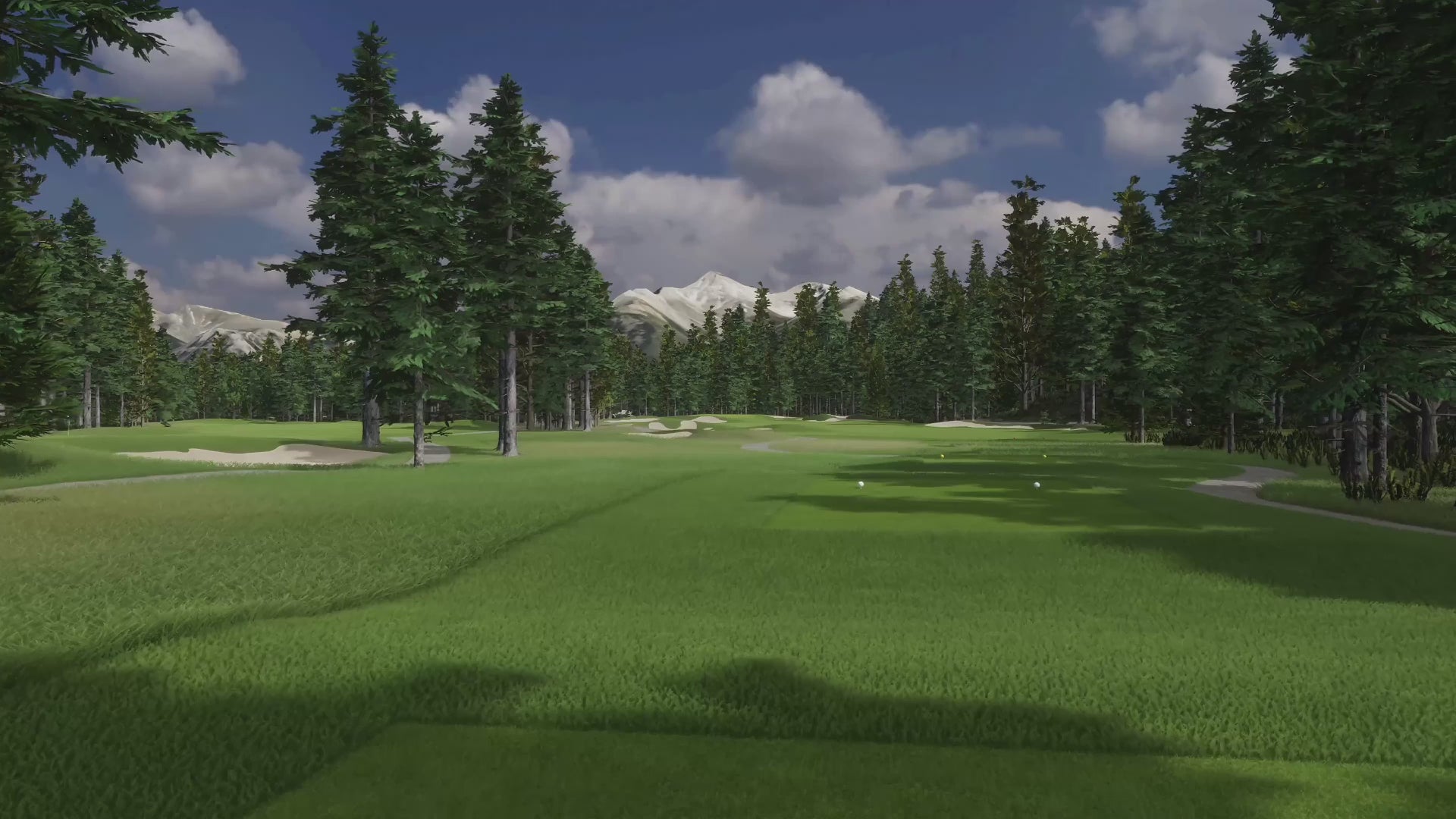 A lush golf course surrounded by tall pine trees, with a clear sky and mountains in the background.