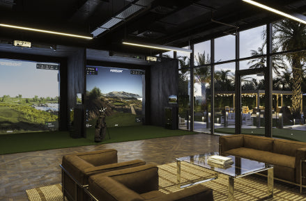 Two indoor launch monitors set up side by side in home