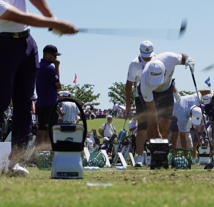 A group of men on the putting greens using their Foresight Sports launch monitors